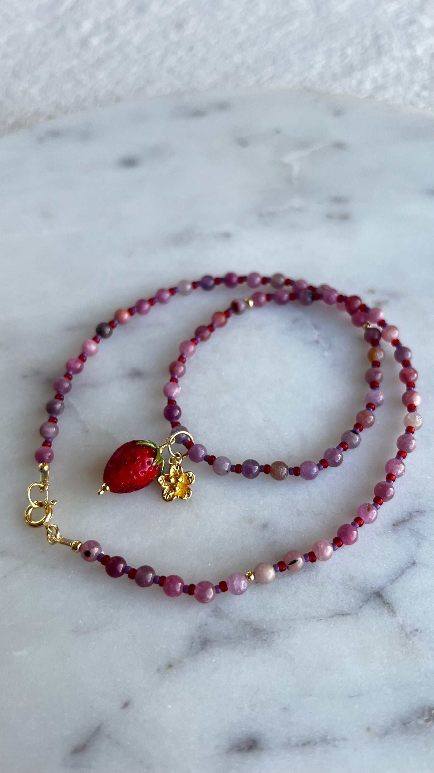 Naszyjnik z rubinu jasnego z truskawką i rozkwitającym kwiatem.